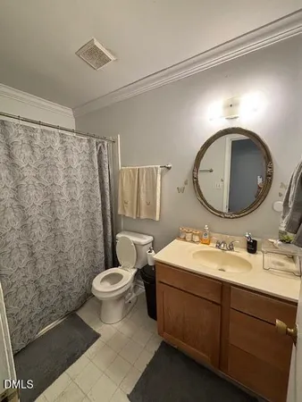 a bathroom with a toilet sink mirror vanity and shower
