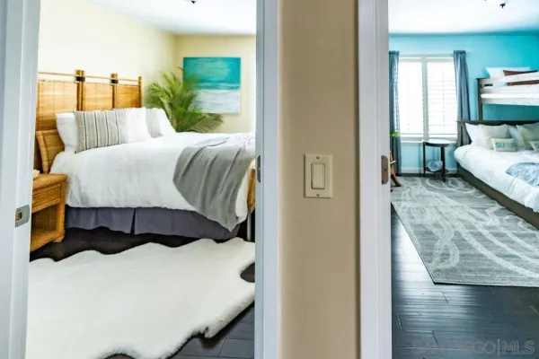 a bedroom with a bed and a lamp on dresser