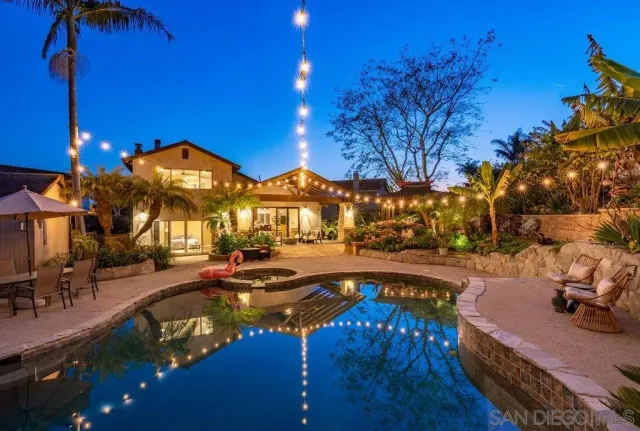a view of a house with swimming pool and sitting area