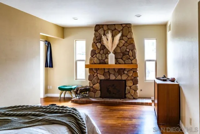 a bedroom with a bed and a fireplace