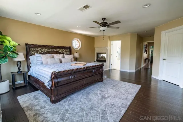 a spacious bedroom with a bed and a chandelier