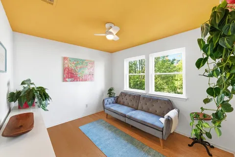 a bathroom with a sink vanity mirror bathtub and toilet