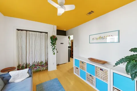 a bedroom with bed and a potted plant