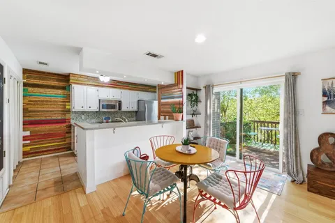 a kitchen with a table and chairs in it