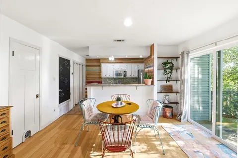 a dining room with furniture and a window
