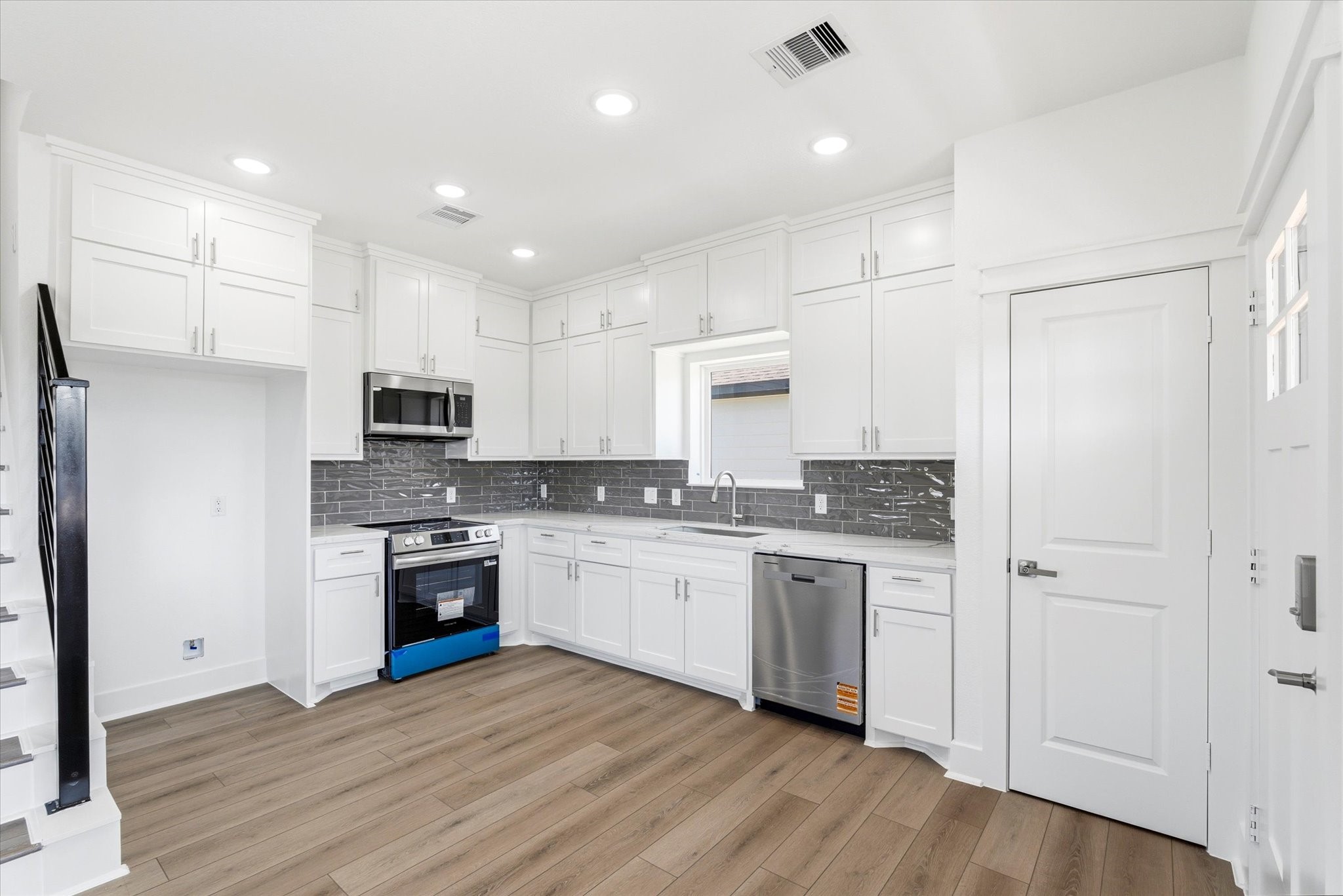 230 South Y Street La Porte, TX 77571 - Photo 4 of 15 a kitchen with stainless steel appliances granite countertop a stove top oven a sink and a refrigerator