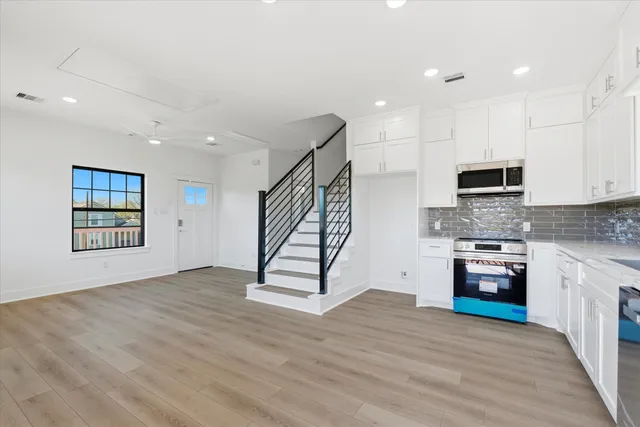 a view of a kitchen with a sink dishwasher and a fireplace