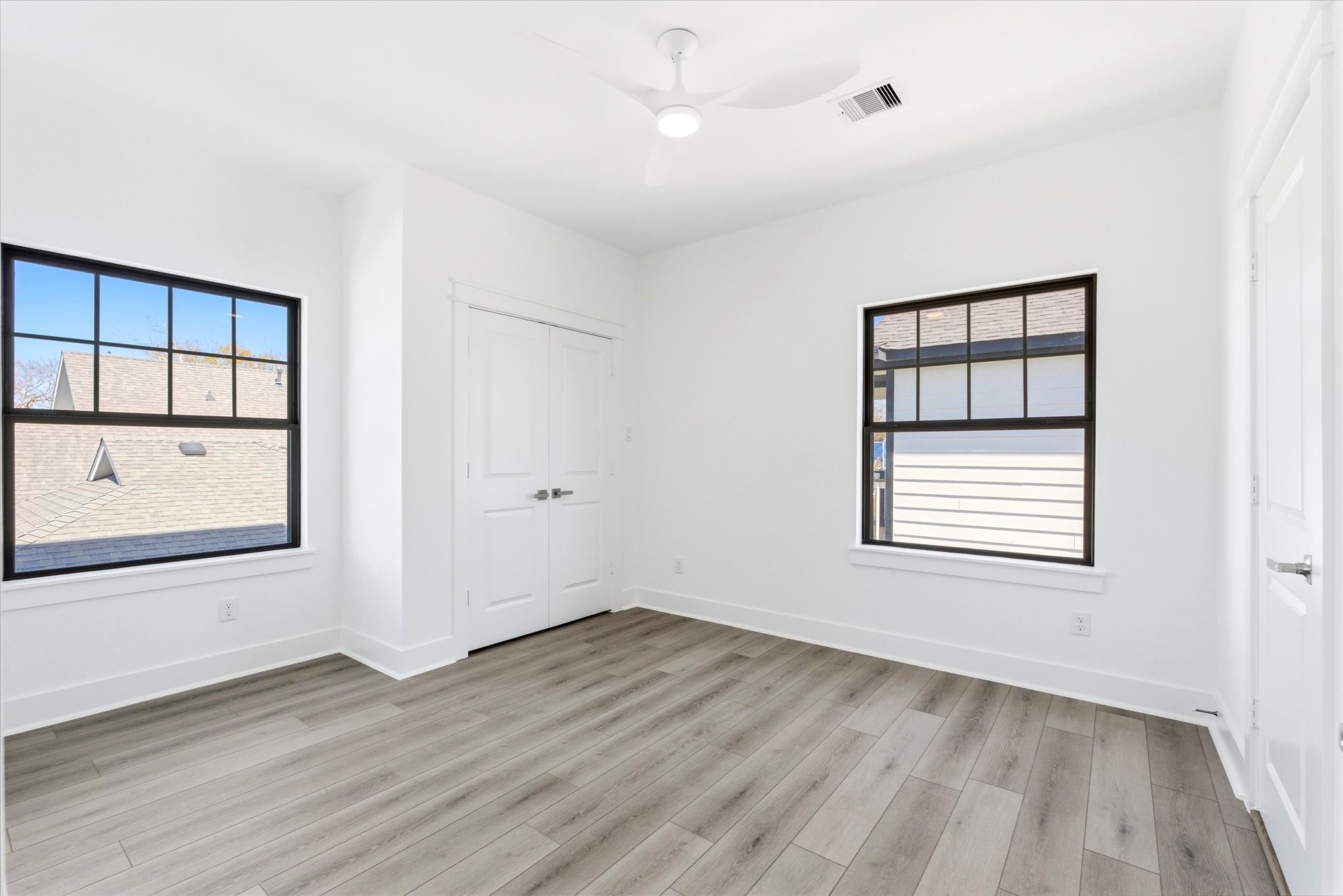 230 South Y Street La Porte, TX 77571 - Photo 9 of 15 an empty room with wooden floor and windows
