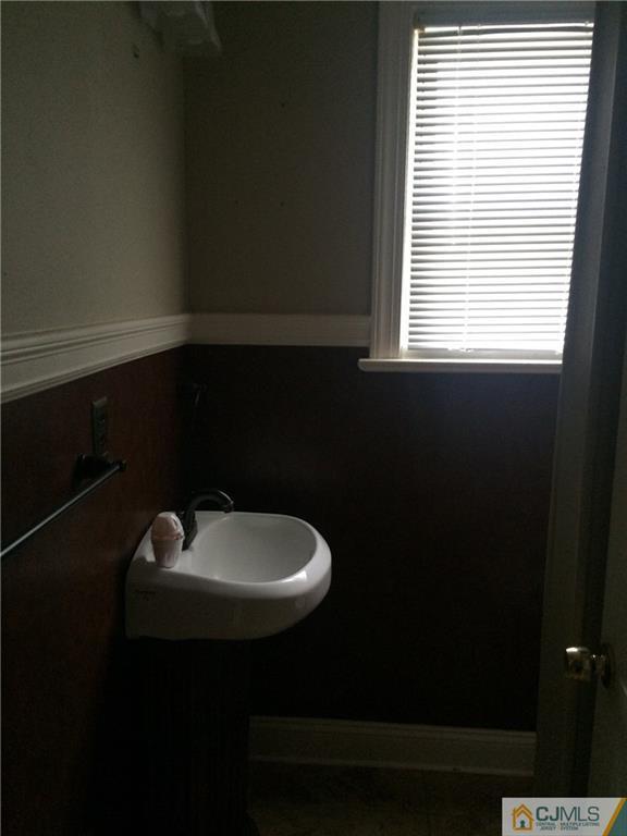 95 Westons Mill Road East Brunswick, NJ 08816 - Photo 13 of 22 a bathroom with a sink a toilet and a window
