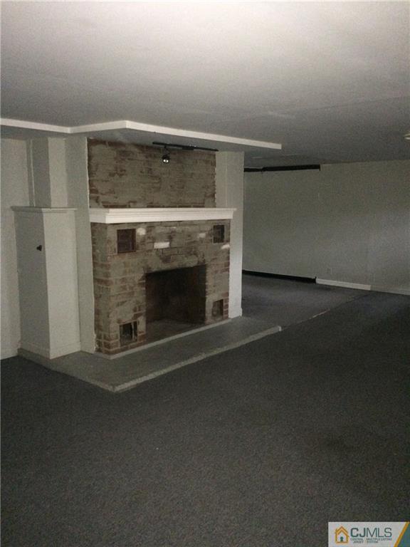 95 Westons Mill Road East Brunswick, NJ 08816 - Photo 16 of 22 a living room with a fireplace