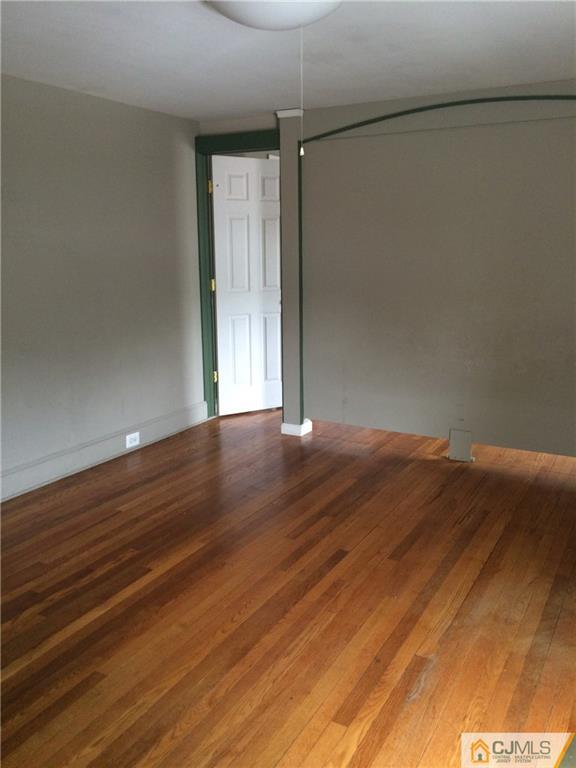 95 Westons Mill Road East Brunswick, NJ 08816 - Photo 17 of 22 an empty room with wooden floor and windows