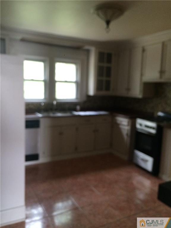 95 Westons Mill Road East Brunswick, NJ 08816 - Photo 3 of 22 a kitchen with a sink and cabinets