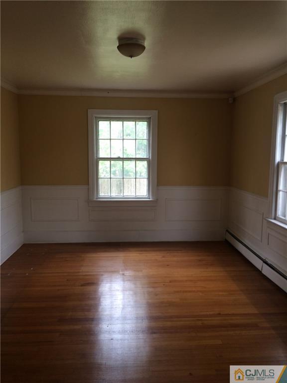 95 Westons Mill Road East Brunswick, NJ 08816 - Photo 6 of 22 an empty room with wooden floor and windows