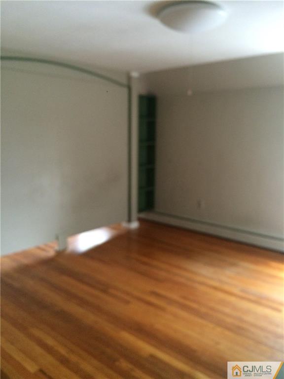 95 Westons Mill Road East Brunswick, NJ 08816 - Photo 7 of 22 a view of empty room with wooden floor