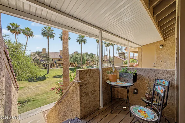 a balcony with furniture and a potted plant