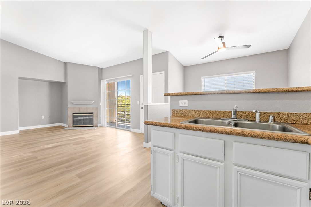 3318 North Decatur Boulevard, Unit 2152 Las Vegas, NV 89130 - Photo 14 of 58 A well-appointed kitchen overlooks an inviting living area with a fireplace and outdoor access.