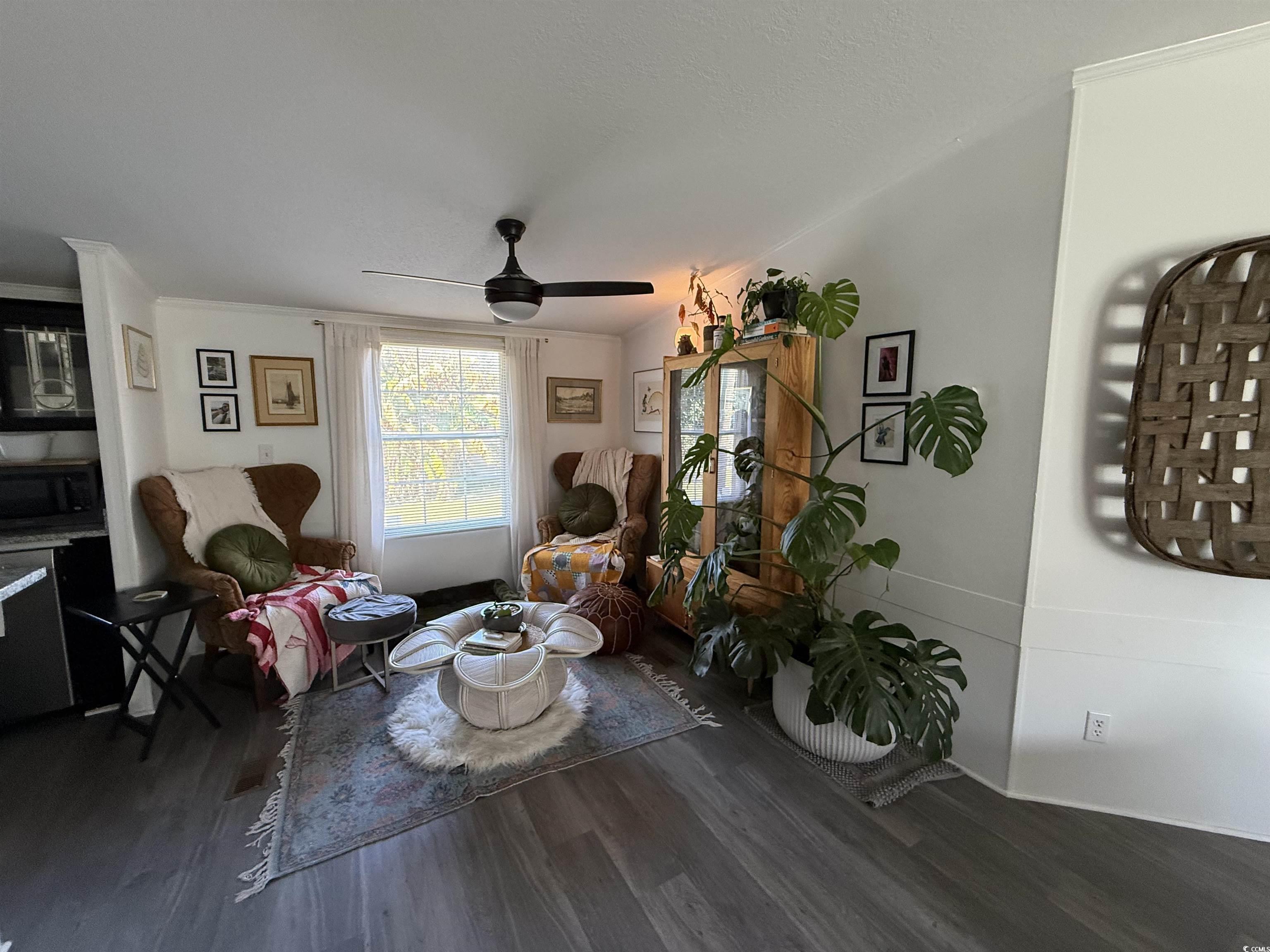 19 Gates Way Pawleys Island, SC 29585 - Photo 13 of 18 Sitting room with ceiling fan, dark wood finished floors, and ornamental molding