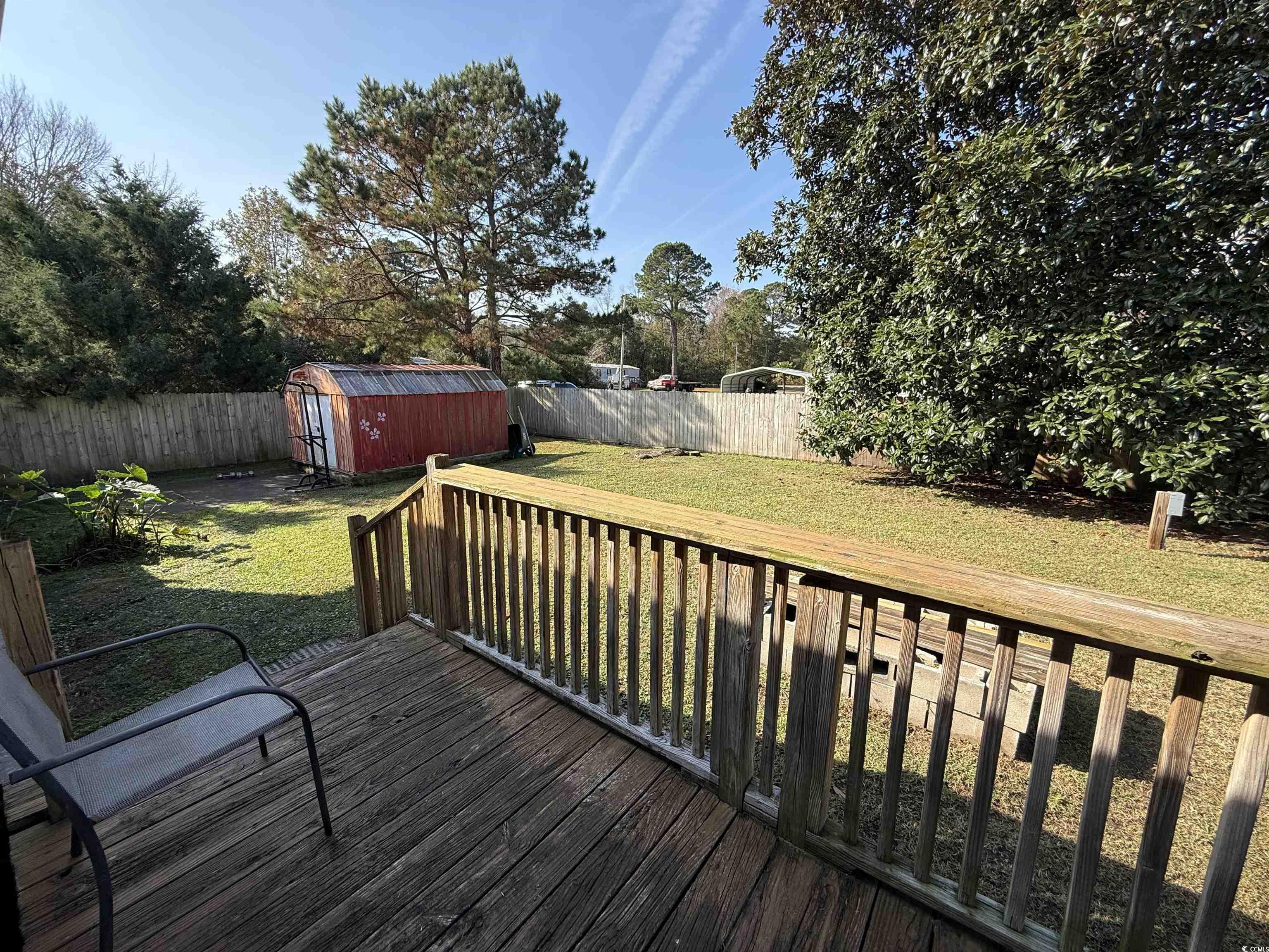 19 Gates Way Pawleys Island, SC 29585 - Photo 16 of 18 Wooden terrace with a fenced backyard and a storage shed