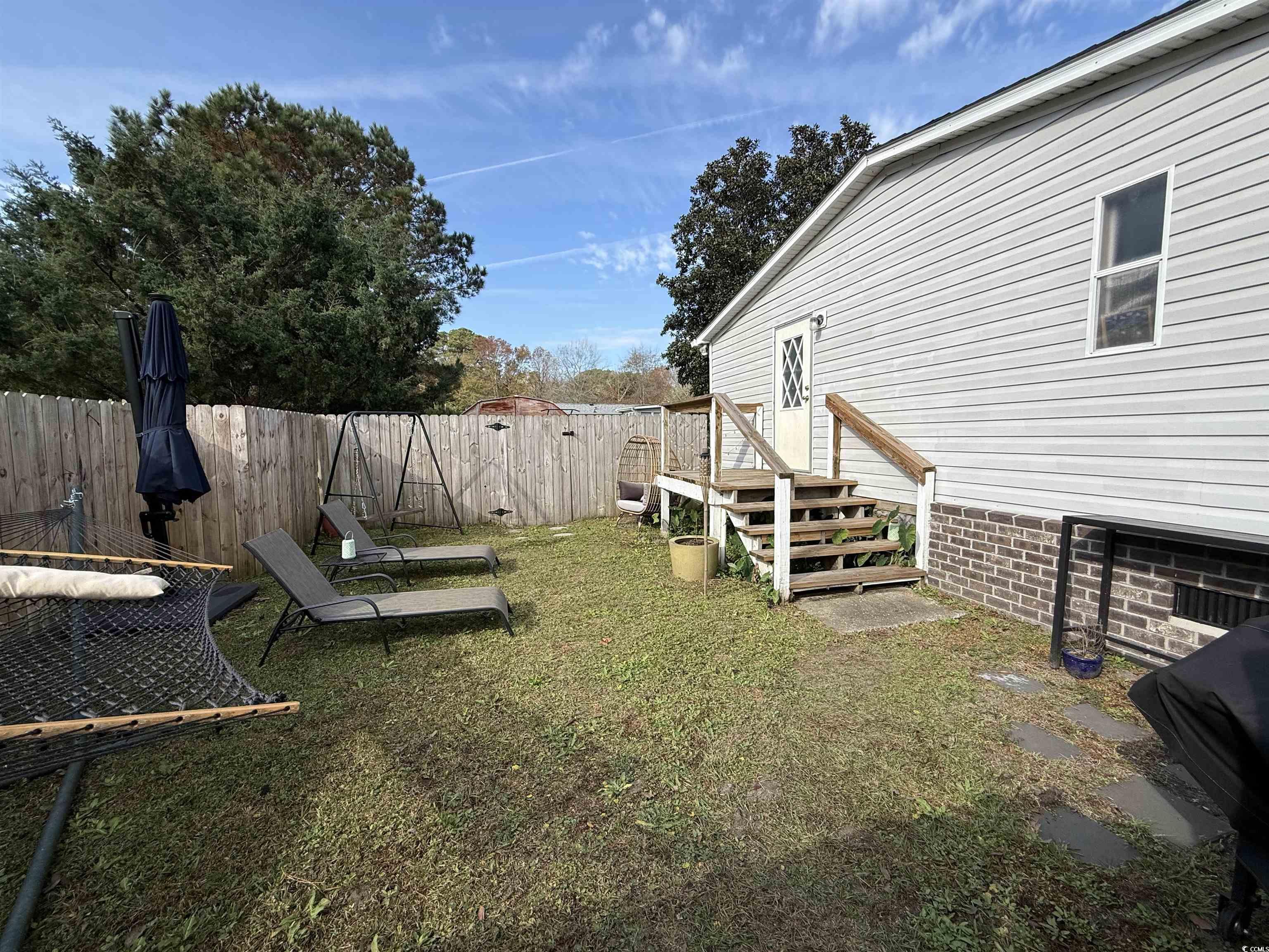 19 Gates Way Pawleys Island, SC 29585 - Photo 2 of 18 View of fenced backyard