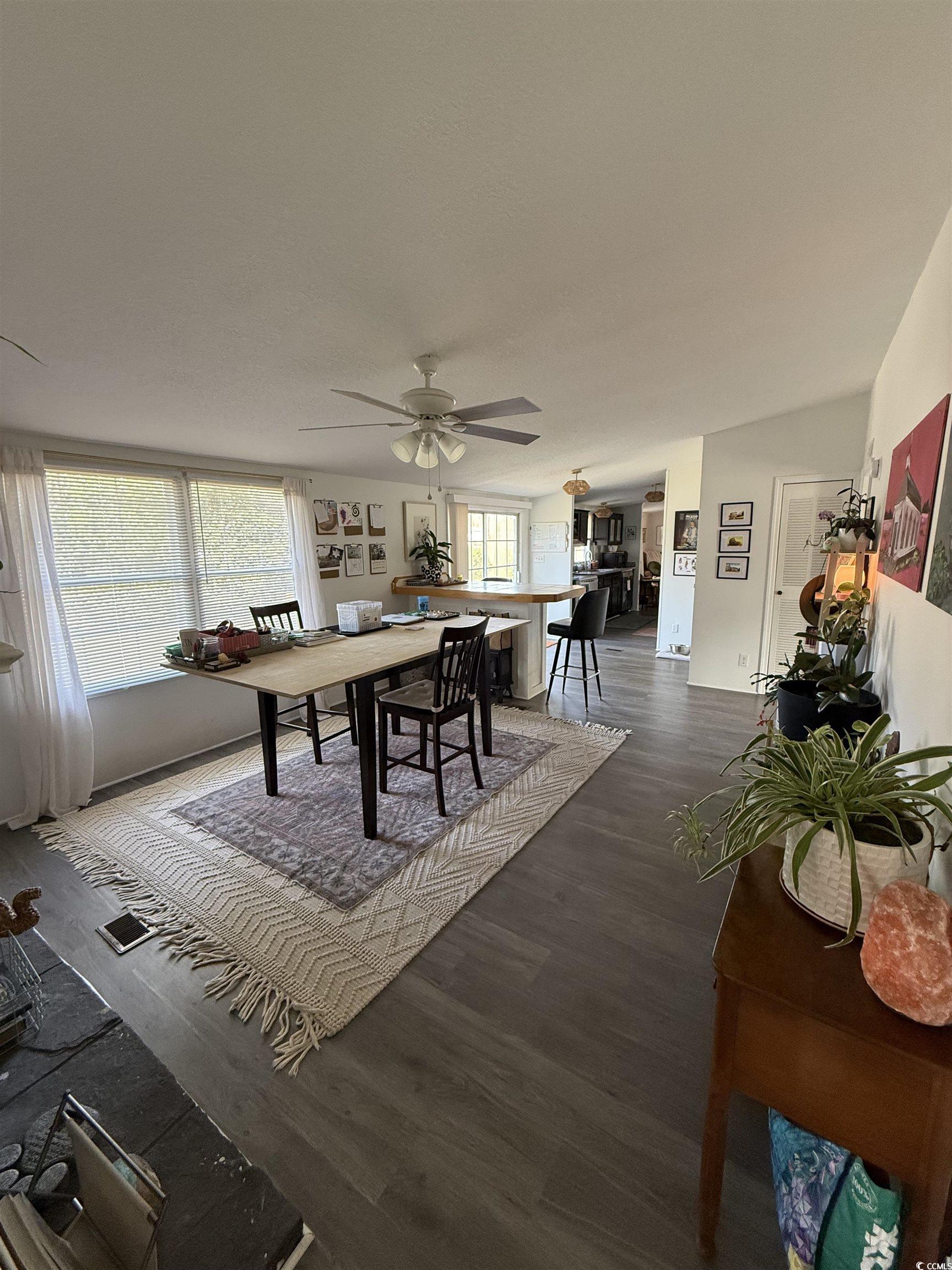 19 Gates Way Pawleys Island, SC 29585 - Photo 4 of 18 Dining area with dark wood finished floors and a ceiling fan
