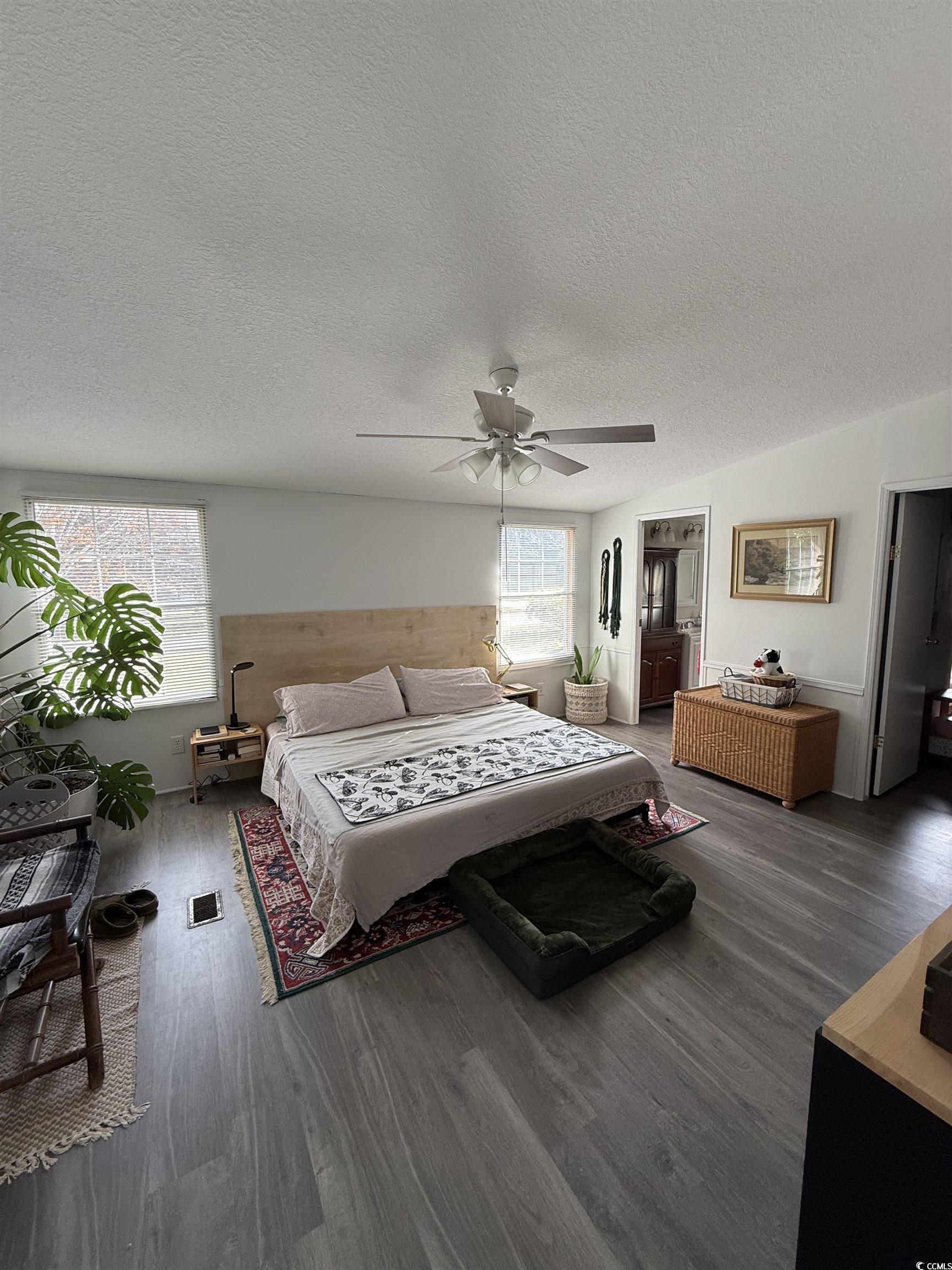 19 Gates Way Pawleys Island, SC 29585 - Photo 7 of 18 Bedroom with wood finished floors, a ceiling fan, and a textured ceiling