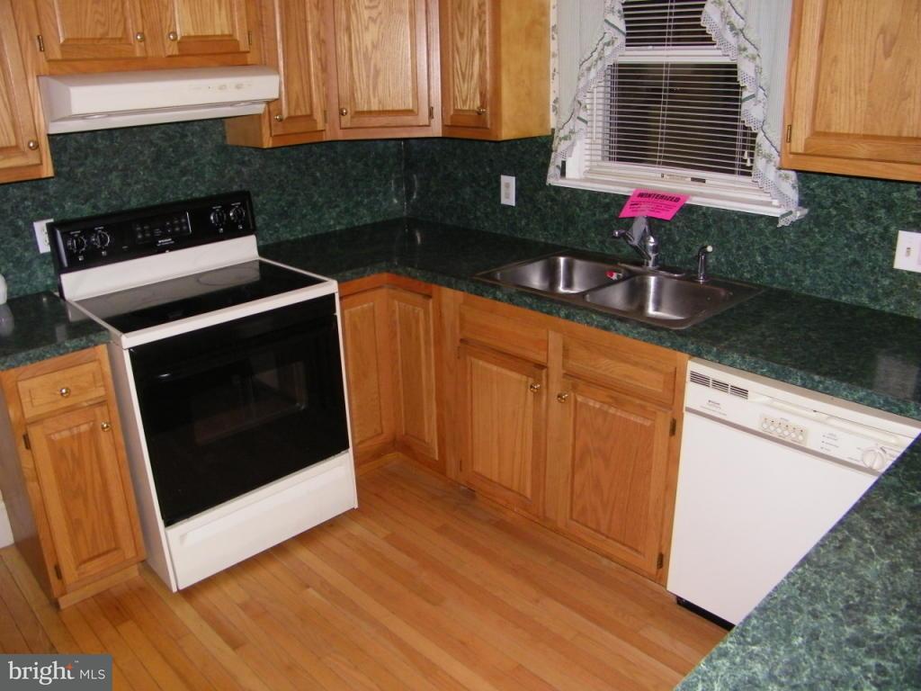 257 Frogtown Road Pequea, PA 17565 - Photo 2 of 9 a kitchen with granite countertop a stove a sink and a microwave