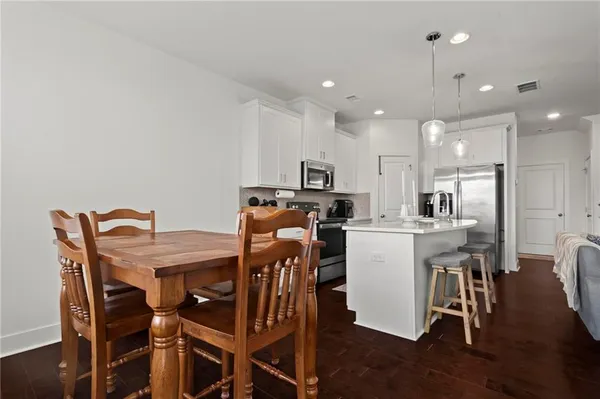 a view of a dining room with furniture and wooden floor