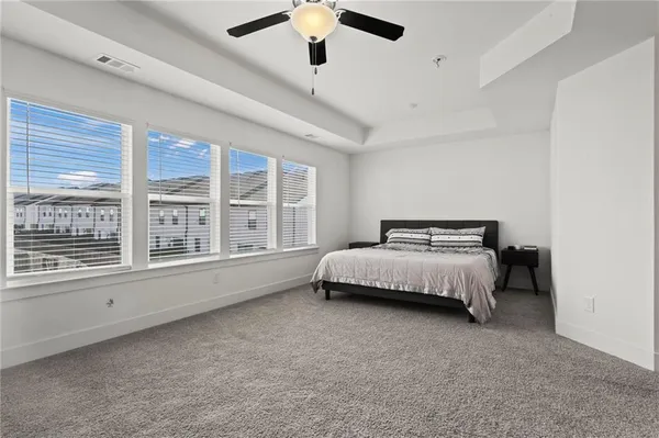 a bedroom with a bed and a large window