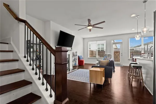 a living room with fireplace furniture wooden floor and a flat screen tv
