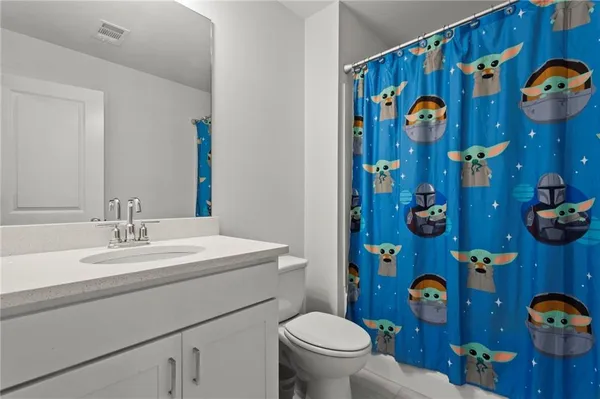 a bathroom with a sink and mirror with toilet
