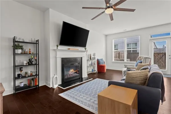 a living room with furniture a flat screen tv and a fireplace
