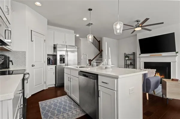 a kitchen with a stove a sink and a refrigerator