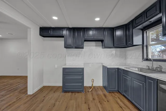 a kitchen with a sink and wooden cabinets