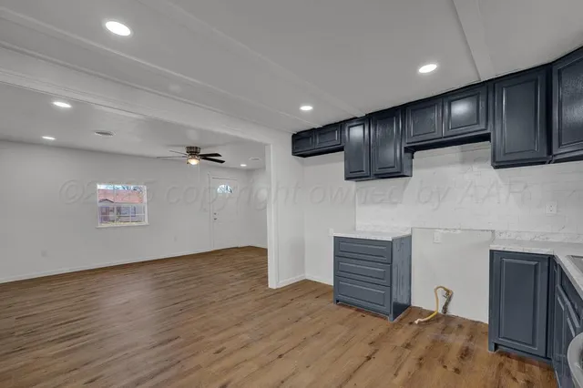 a view of empty room with wooden floor and cabinet