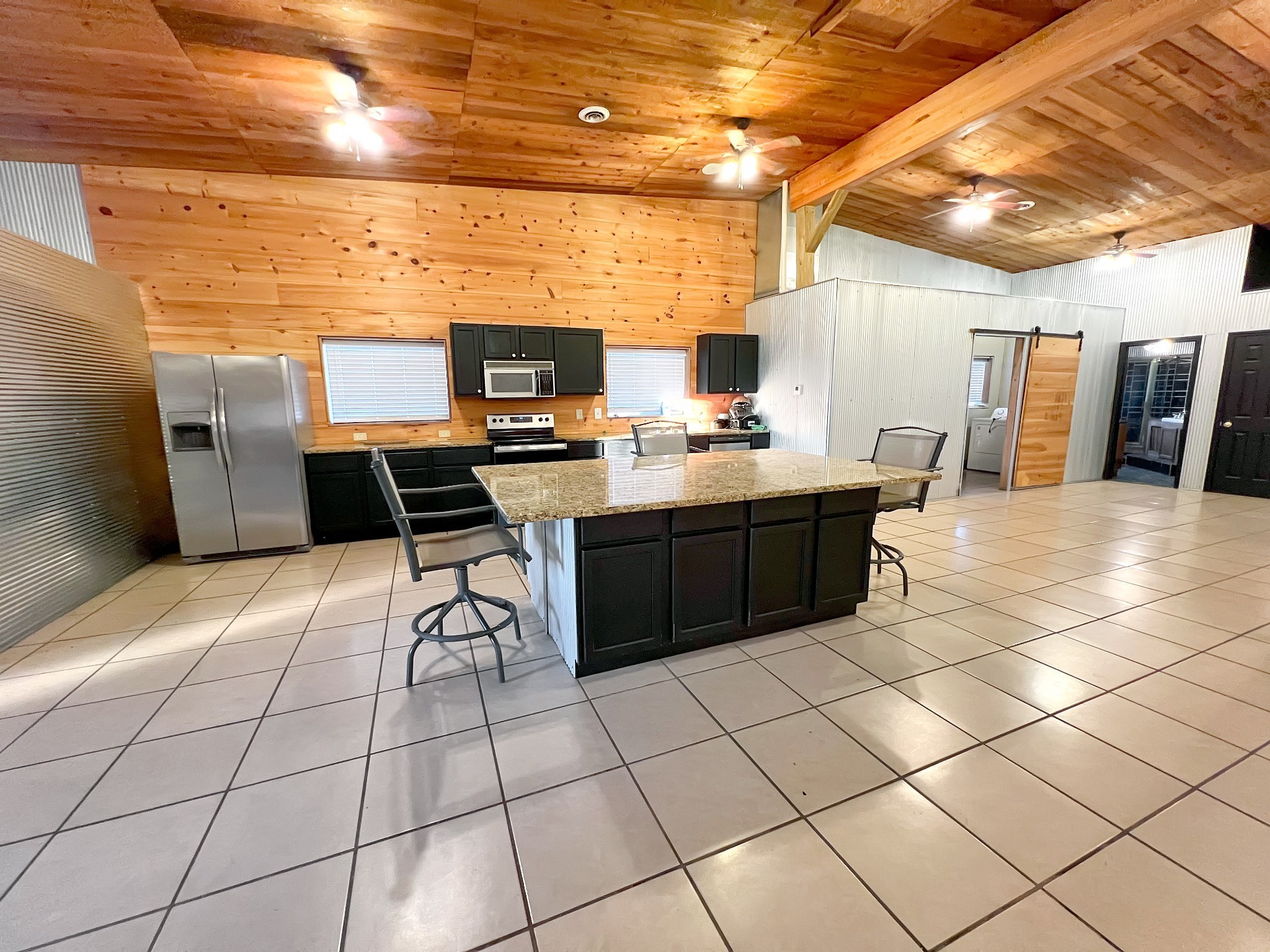 2982 Harvey Bowden Road Springville, TN 38256 - Photo 40 of 48 a kitchen with stainless steel appliances a sink counter top space and cabinets