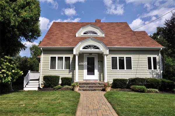 65 Columbia Road Arlington, MA 02474 - Photo 1 of 30 a front view of a house with a yard