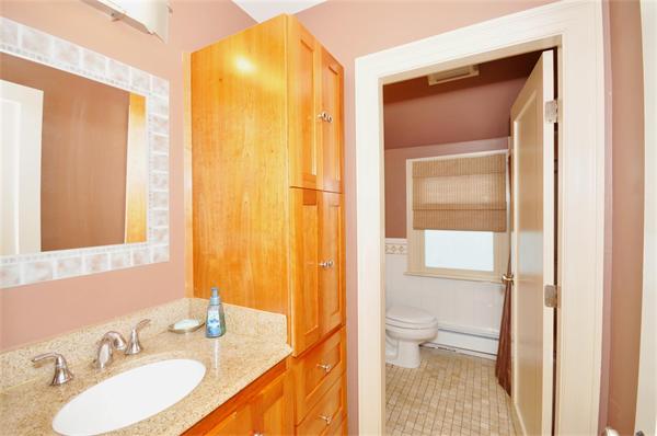 65 Columbia Road Arlington, MA 02474 - Photo 19 of 30 a bathroom with a granite countertop sink toilet and shower