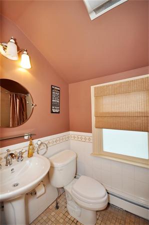 65 Columbia Road Arlington, MA 02474 - Photo 20 of 30 a bathroom with a sink a toilet and mirror