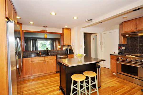 65 Columbia Road Arlington, MA 02474 - Photo 9 of 30 a kitchen with stainless steel appliances granite countertop a stove refrigerator and cabinets