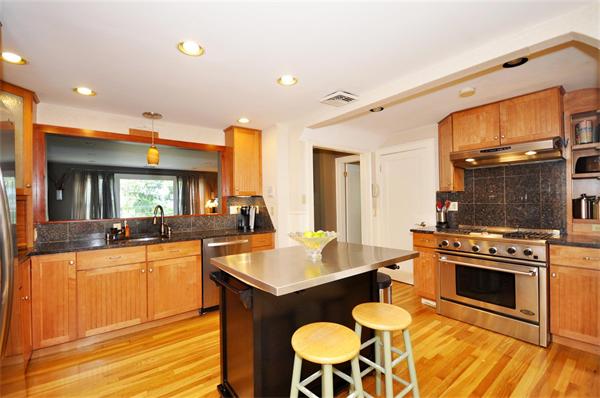 65 Columbia Road Arlington, MA 02474 - Photo 10 of 30 a kitchen with a stove a sink and a refrigerator