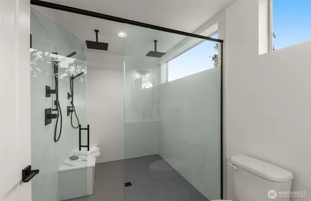 a bathroom with a shower and a toilet