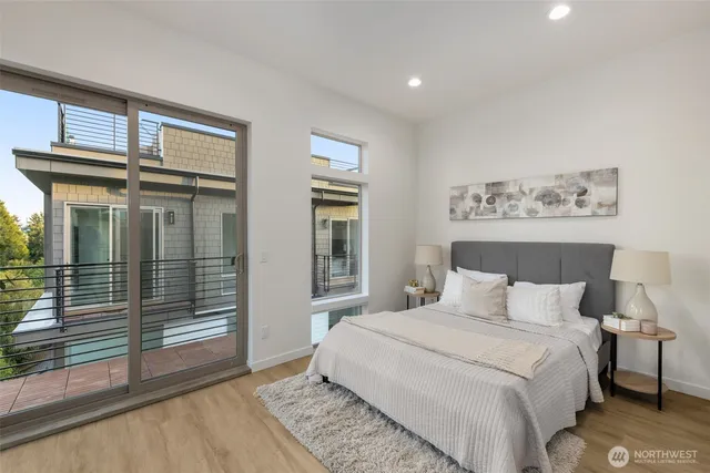 a bedroom with a bed and a large window