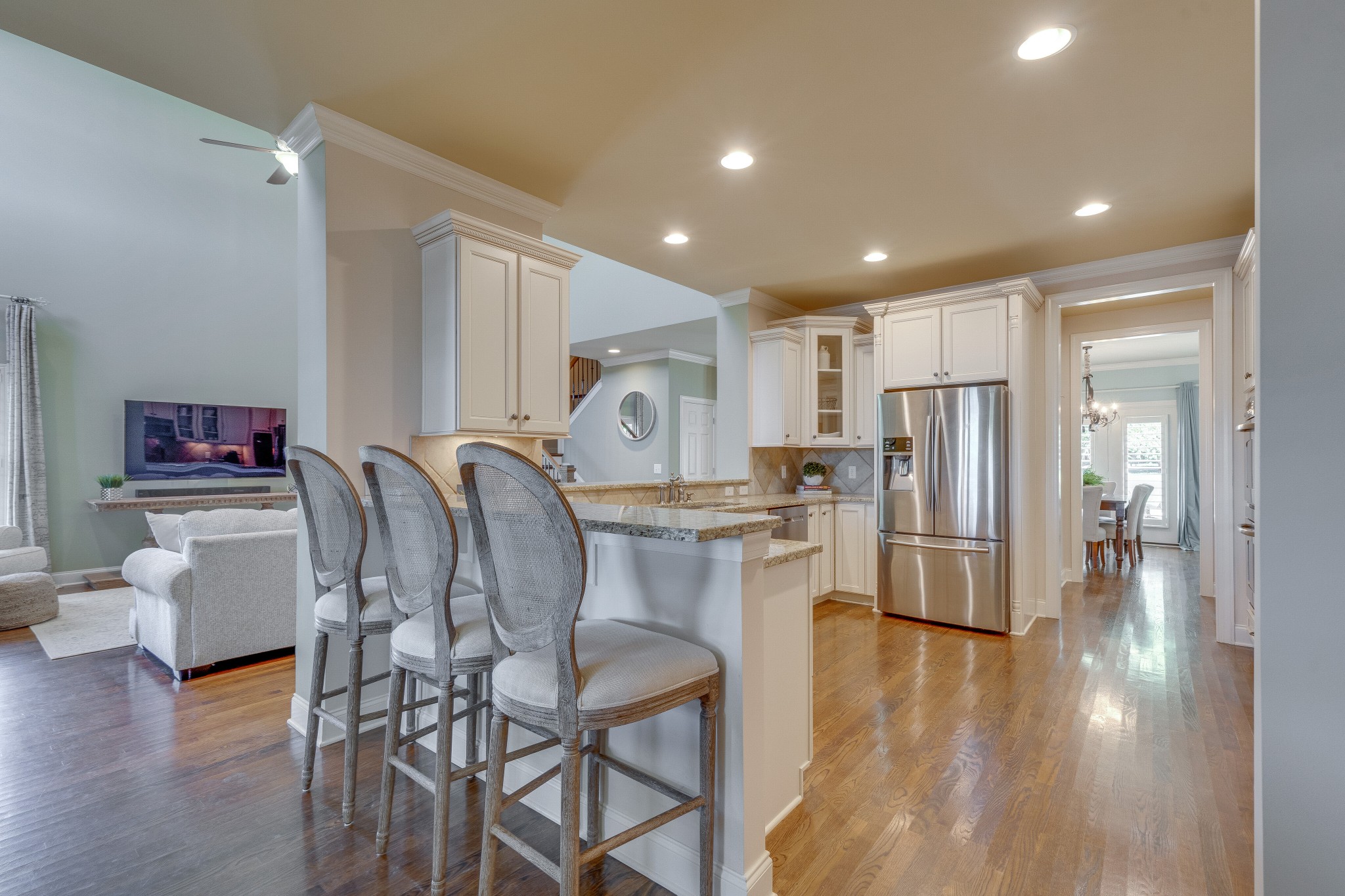 149 Keller Trail Franklin, TN 37064 - Photo 13 of 42 a kitchen with stainless steel appliances a dining table chairs and wooden floor