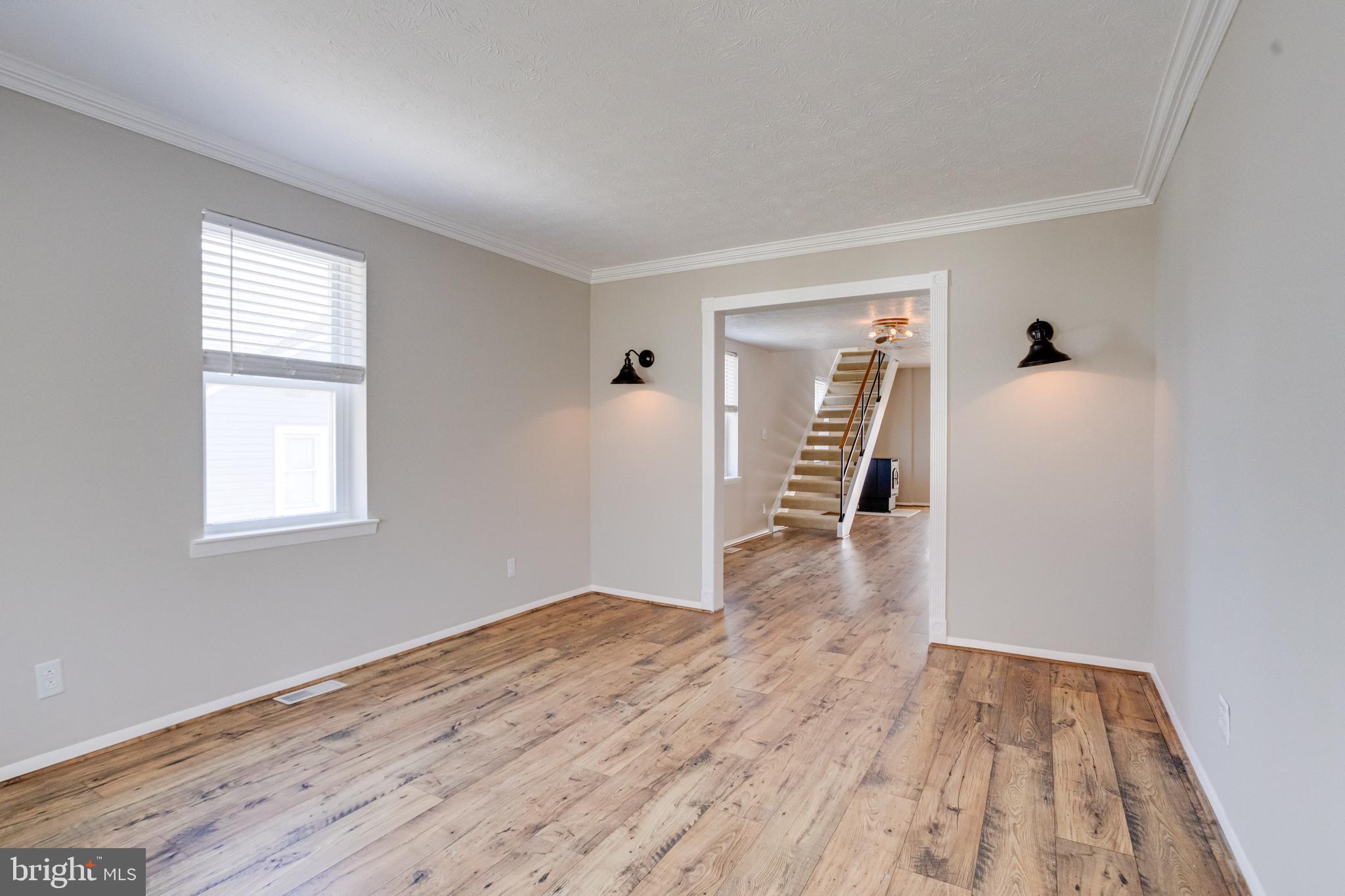 3809 Clarks Point Road Middle River, MD 21220 - Photo 11 of 49 a view of a livingroom with wooden floor and a window