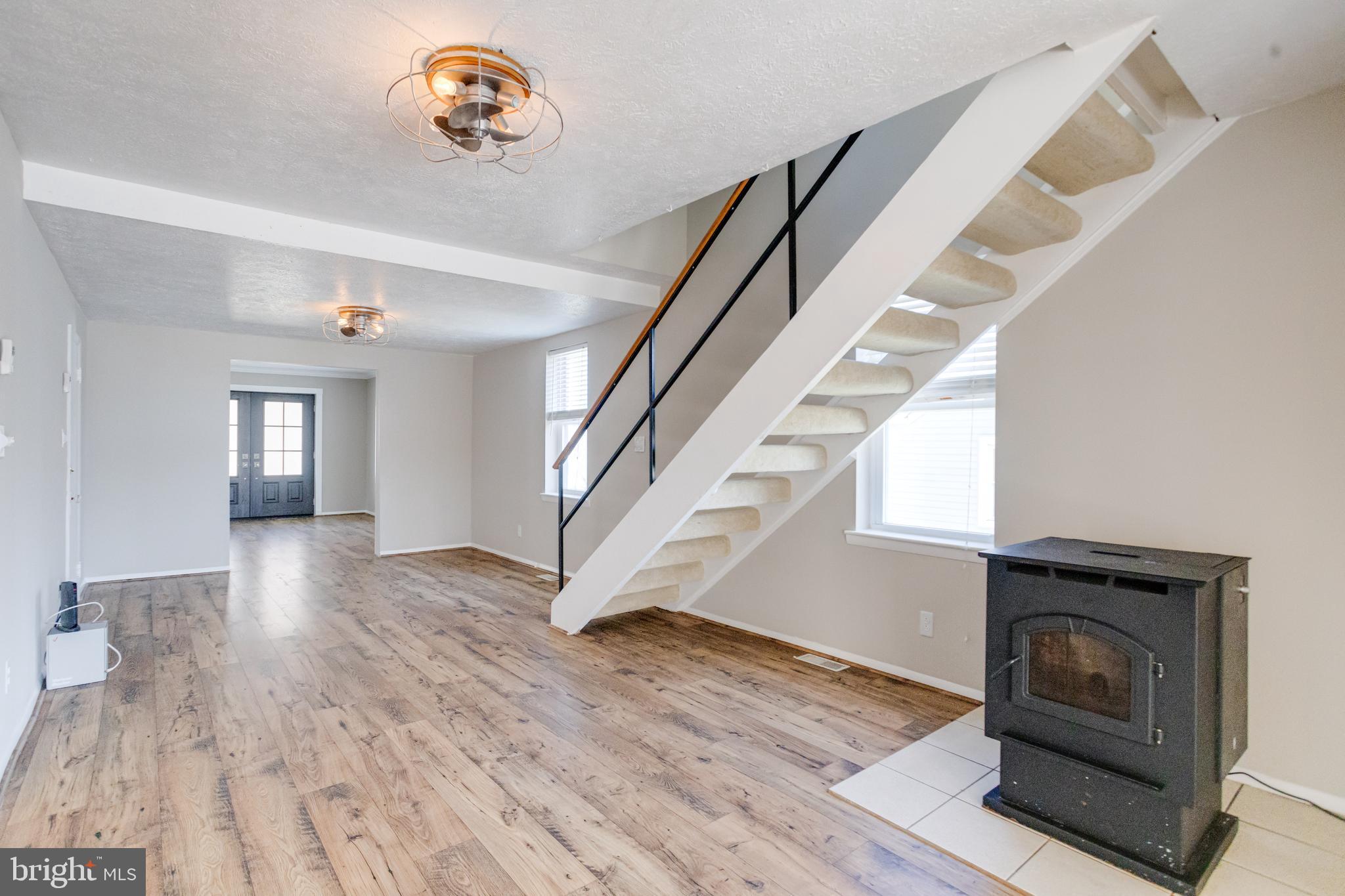 3809 Clarks Point Road Middle River, MD 21220 - Photo 15 of 49 a view of empty room with wooden floor and fan