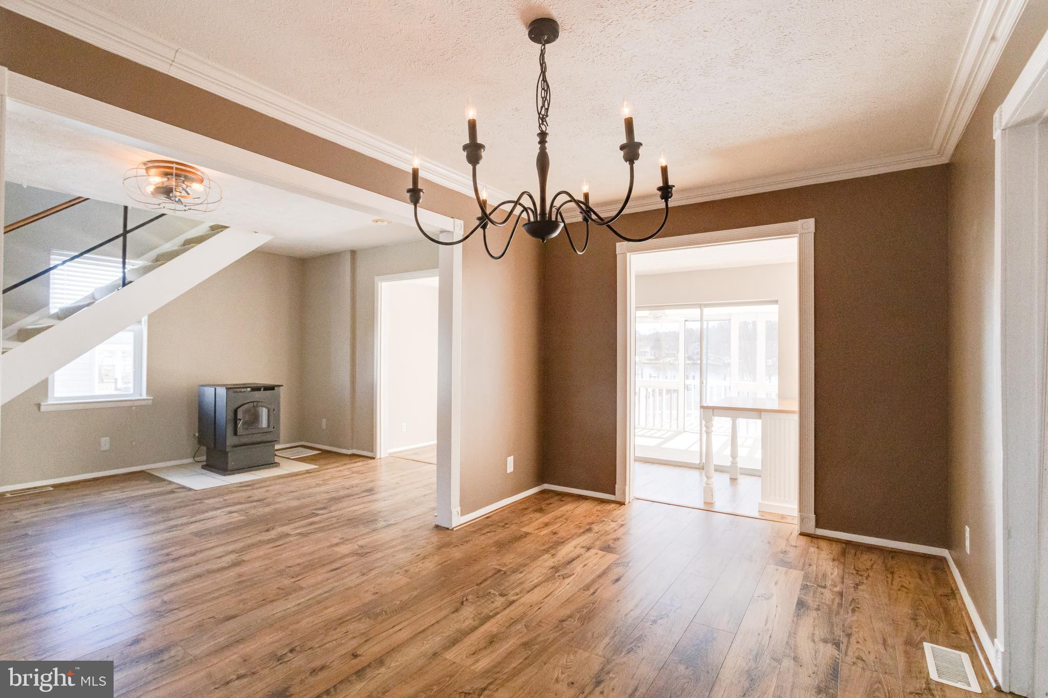 3809 Clarks Point Road Middle River, MD 21220 - Photo 22 of 49 a view of empty room with wooden floor and fan