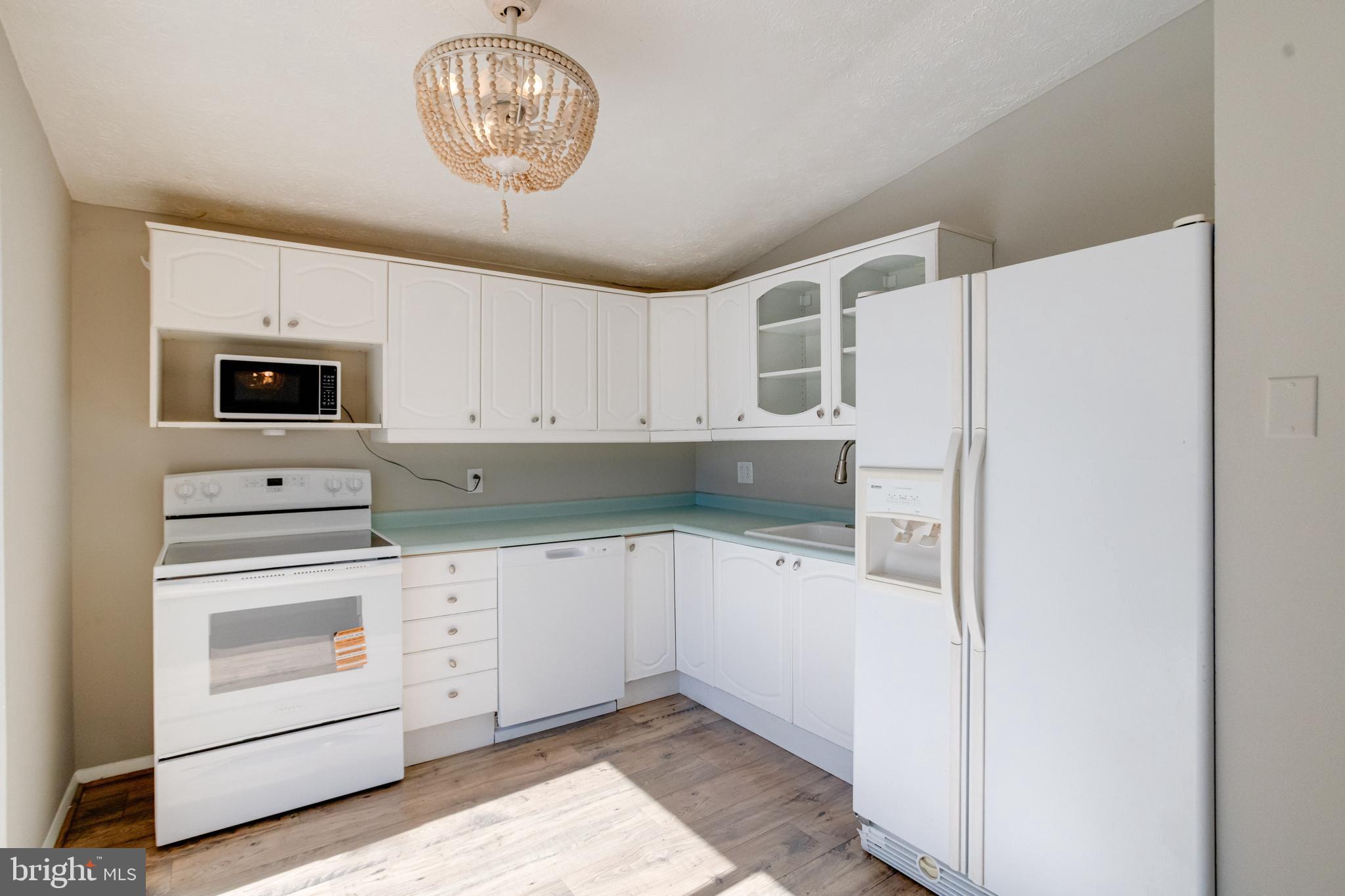 3809 Clarks Point Road Middle River, MD 21220 - Photo 26 of 49 a kitchen with white cabinets and white appliances