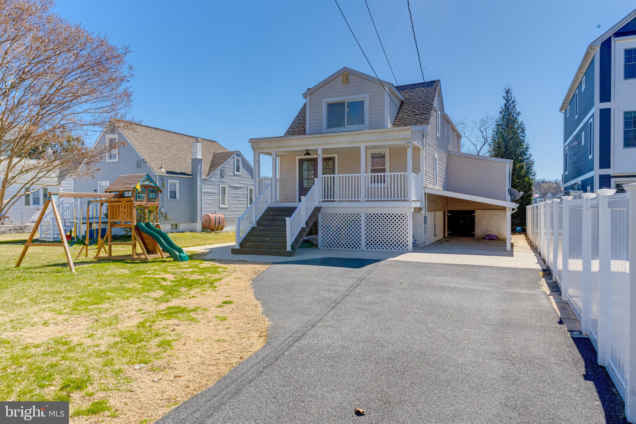 3809 Clarks Point Road Middle River, MD 21220 - Photo 3 of 49 a front view of house with a garden and fire pit