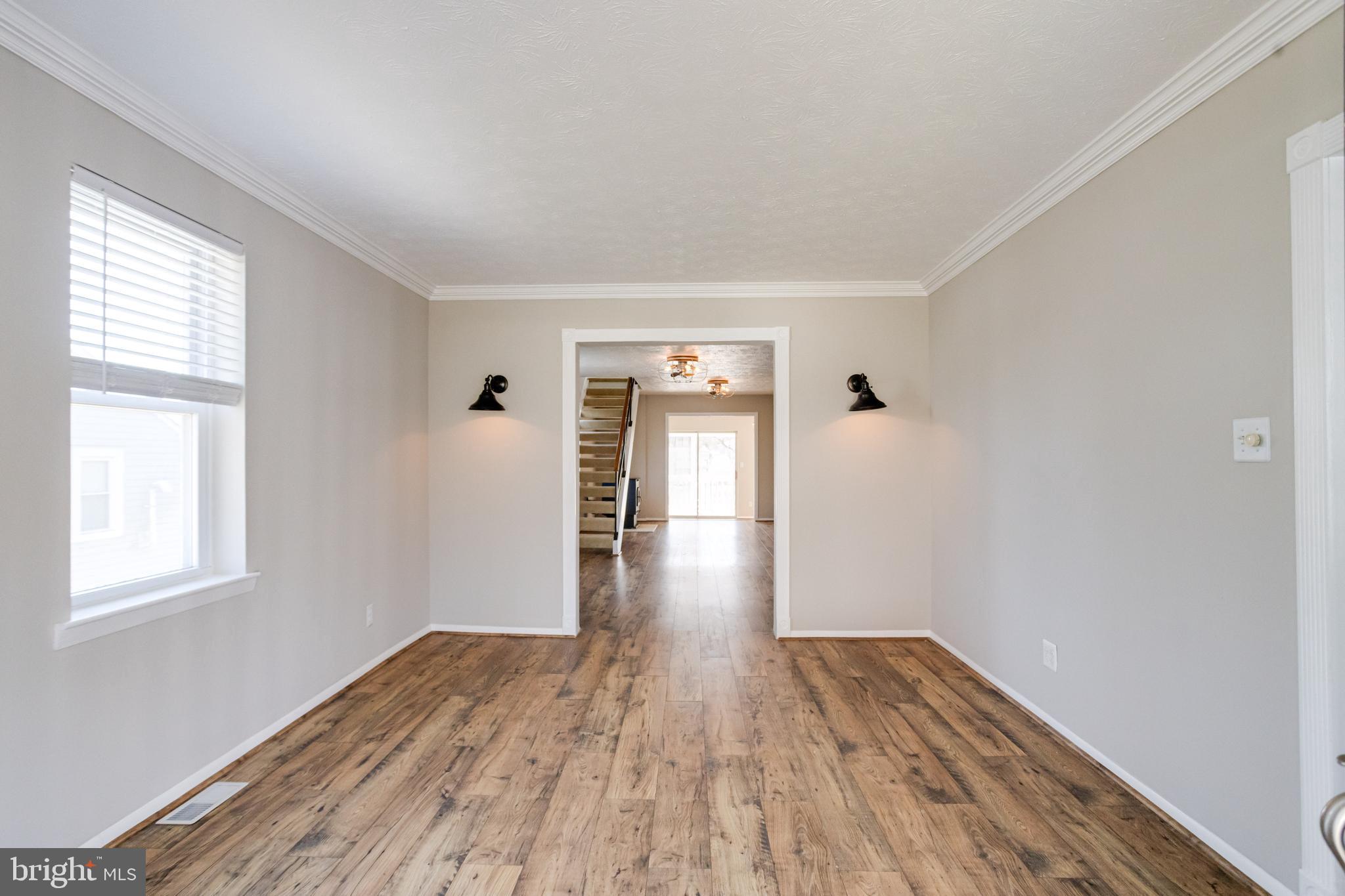 3809 Clarks Point Road Middle River, MD 21220 - Photo 5 of 49 a view of empty room with wooden floor and fan