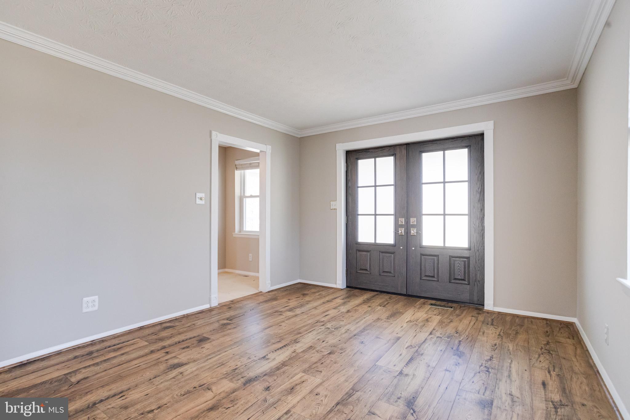 3809 Clarks Point Road Middle River, MD 21220 - Photo 6 of 49 an empty room with wooden floor and windows